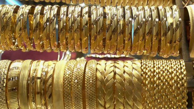 A lot of different gold bracelets in the showcase of a jewelry store. HD video 