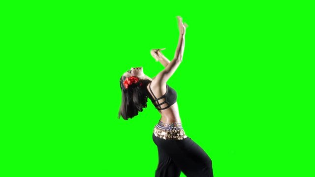 Pretty woman exercising zumba dance while wearing sportswear in the studio. Shot in 4k resolution with green screen background