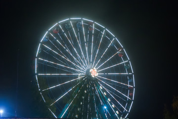 Ferris wheel at the amusement park, night illumination