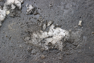 Melting snow asphalt slush water puddle flow dirty street sidewalk