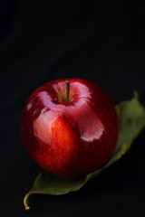 red apple on a leaf