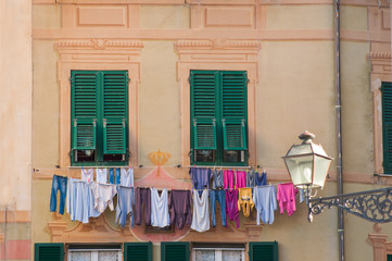 colorful old facade with dry clothes in small village Camogli