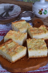 Cottage cheese pie. Homemade baking. Rustic grated cake bars on a wooden board.