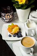 Fruit cake with coffee on the table
