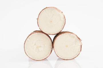 Obraz na płótnie Canvas Raw yucca on white background-Manihot esculenta. (Cassava raw tuber)