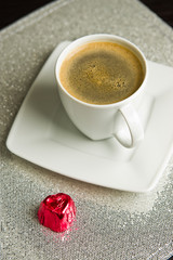Coffee cup with red heart candy