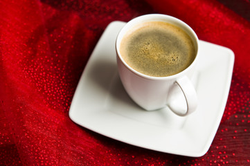 Coffee cup on red background.