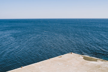 Empty concrete dock on the coast of Adriatic Sea in Ulcinj, Montenegro.