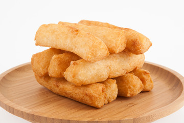 tasty fried yucca sticks on white background