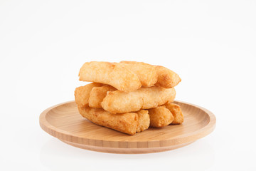 tasty fried yucca sticks on white background