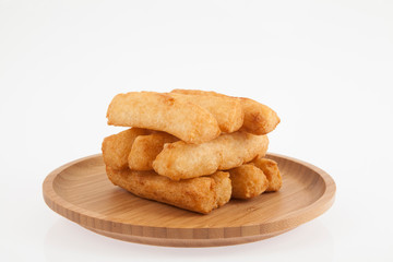 tasty fried yucca sticks on white background