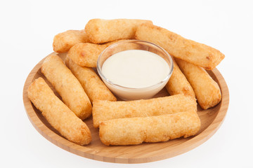 tasty fried yucca sticks on white background