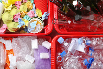 Crates with assorted garbage, top view. Trash recycling
