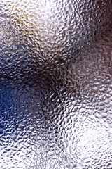 Water drops on glass window close up with blurred background. Drops in macro. Condensate on window closeup. Wet air.