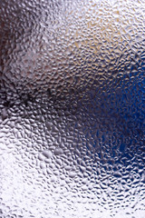 Water drops on glass window close up with blurred background. Drops in macro. Condensate on window closeup. Wet air.