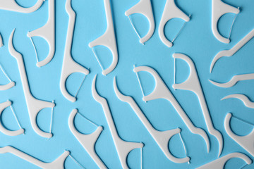Many dental floss picks on color background, top view. Healthy teeth