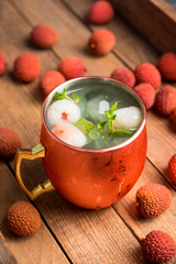 Fresh lychee moscow mule on the rustic background. Selective focus. Shallow depth of field.