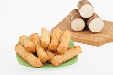 tasty fried yucca sticks on white background