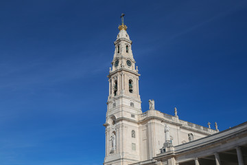 Fototapeta na wymiar Detail of the belltower of the basilica of fatima with a clear sky in summer