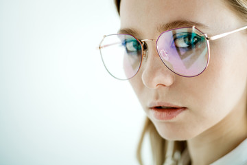 Glasses with a black frame on a young model. Concept photo of products for vision correction.