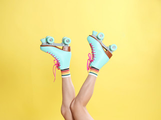 Young woman with retro roller skates on color background, closeup © New Africa
