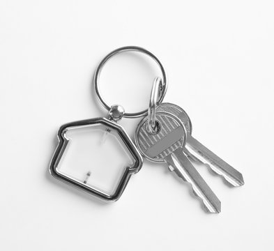 House Keys With Trinket On White Background, Top View