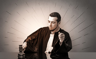 Young dashing judge in black gown making decision