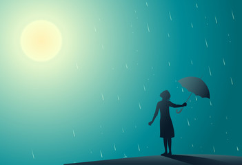 Young girl standing in the rain pulls aside umbrella to look at bright sun,