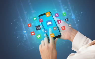 Female hand using smartphone with colorful application icons around