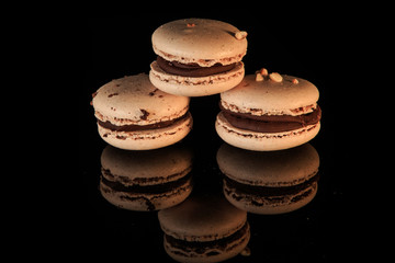 pyramid of three peanut macarons with chocolate filling