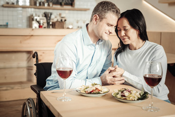 Cheerful couple holding each other hands
