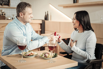 Smiling man proposing to differently abled woman