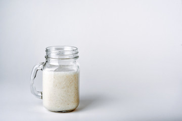 Protein cocktail with milk, vanilla in a glass jar with straws. Sports nutrition
