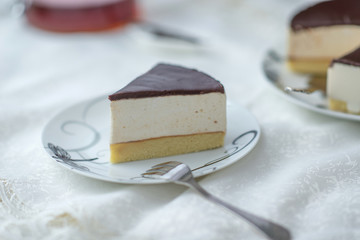 white souffle cake bird's milk with dark icing