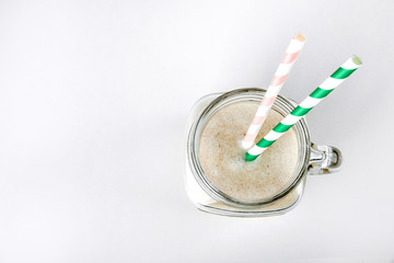 Protein cocktail with milk, vanilla in a glass jar with straws. Sports nutrition