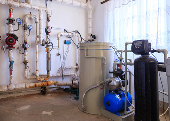 Technological equipment of small gas boiler house. Pipes for gas and for water. Electric pumps. Gas...
