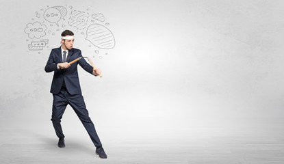 Young businessman in suit fighting with doodled symbols concept
