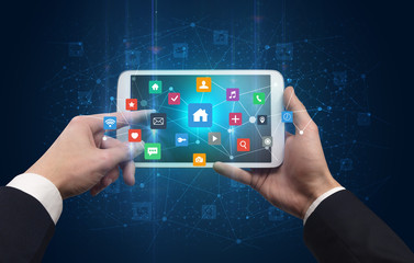 Hand using tablet with colorful bounce application symbols and icons concept
