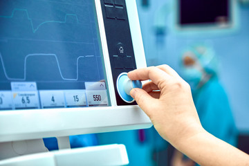 Monitoring patient's vital sign in operating room. doctor cheking at patient's vital signs. Cardiogram monitor during surgery in operation room.