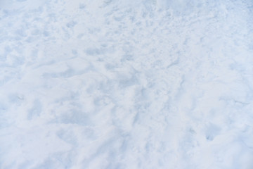 Fototapeta na wymiar Men's feet trace on the real winter snow