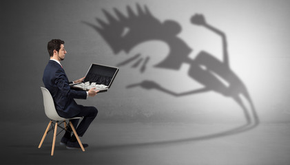 Young businessman staying and  negotiate with a monster shadow
