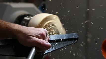 woodturning handicraft of rotating wood with flying shavings