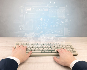 Elegant businessman hand typing with financial, report, graph, chart concept
