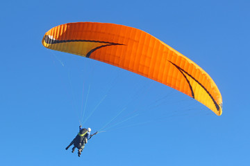 Tandem paraglider flying