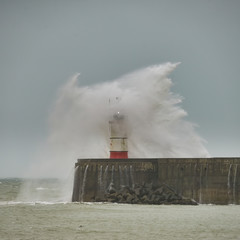 Stunning dangerous high waves crashing over harbor wall during windy Winter storm at Newhaven on English coast