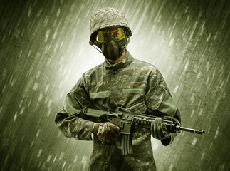 Armed soldier standing in rainy weather
