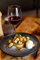 English apple crumble with nuts, mint and ice cream ball
