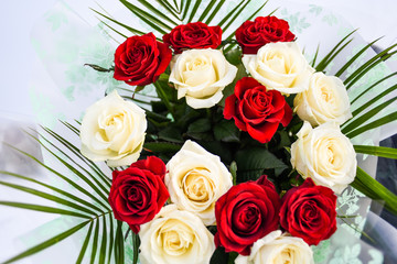 a large bouquet of roses and a golden ring on a white background. 