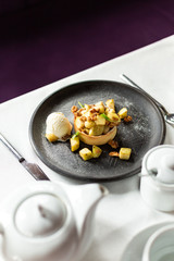 English apple crumble with nuts, mint and ice cream ball