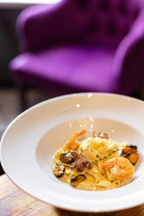 Kraft paste with seafood: mussels, shrimps and octopus in a creamy sauce